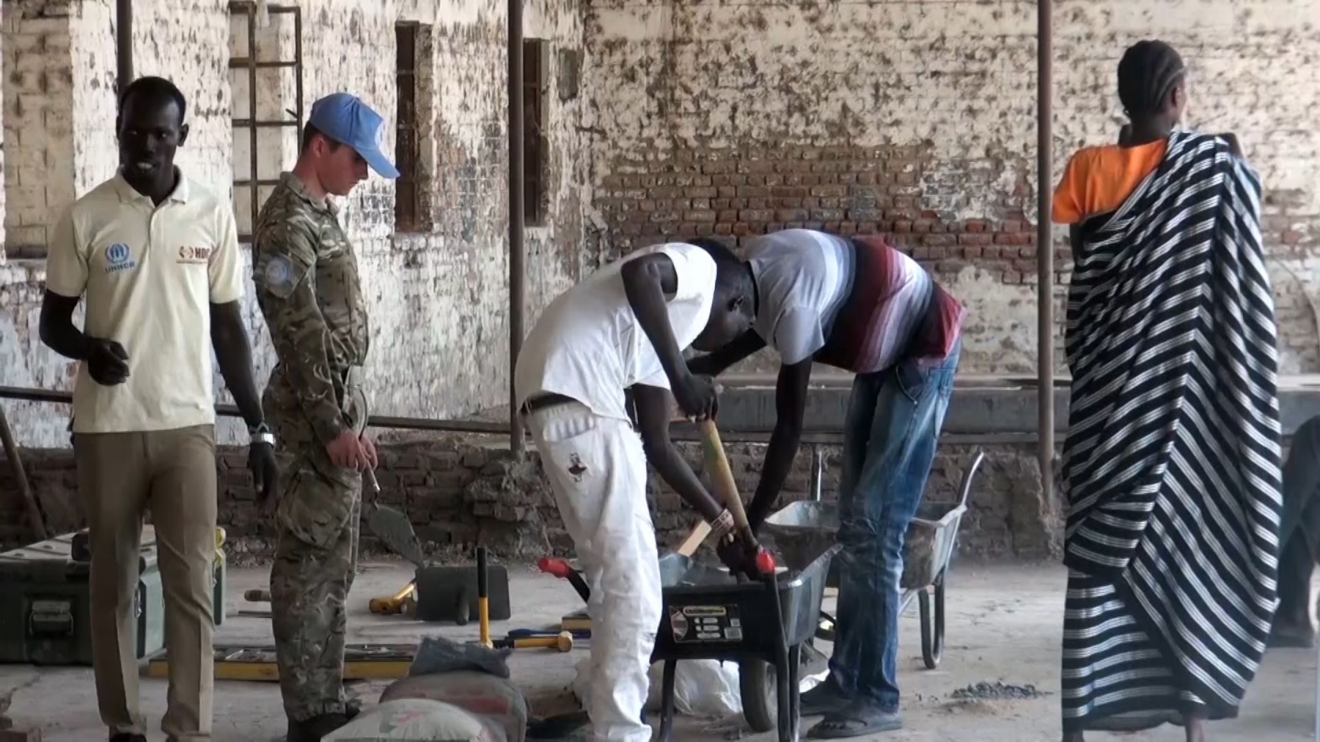 Young South Sudanese men attend a bricklaying workshop.